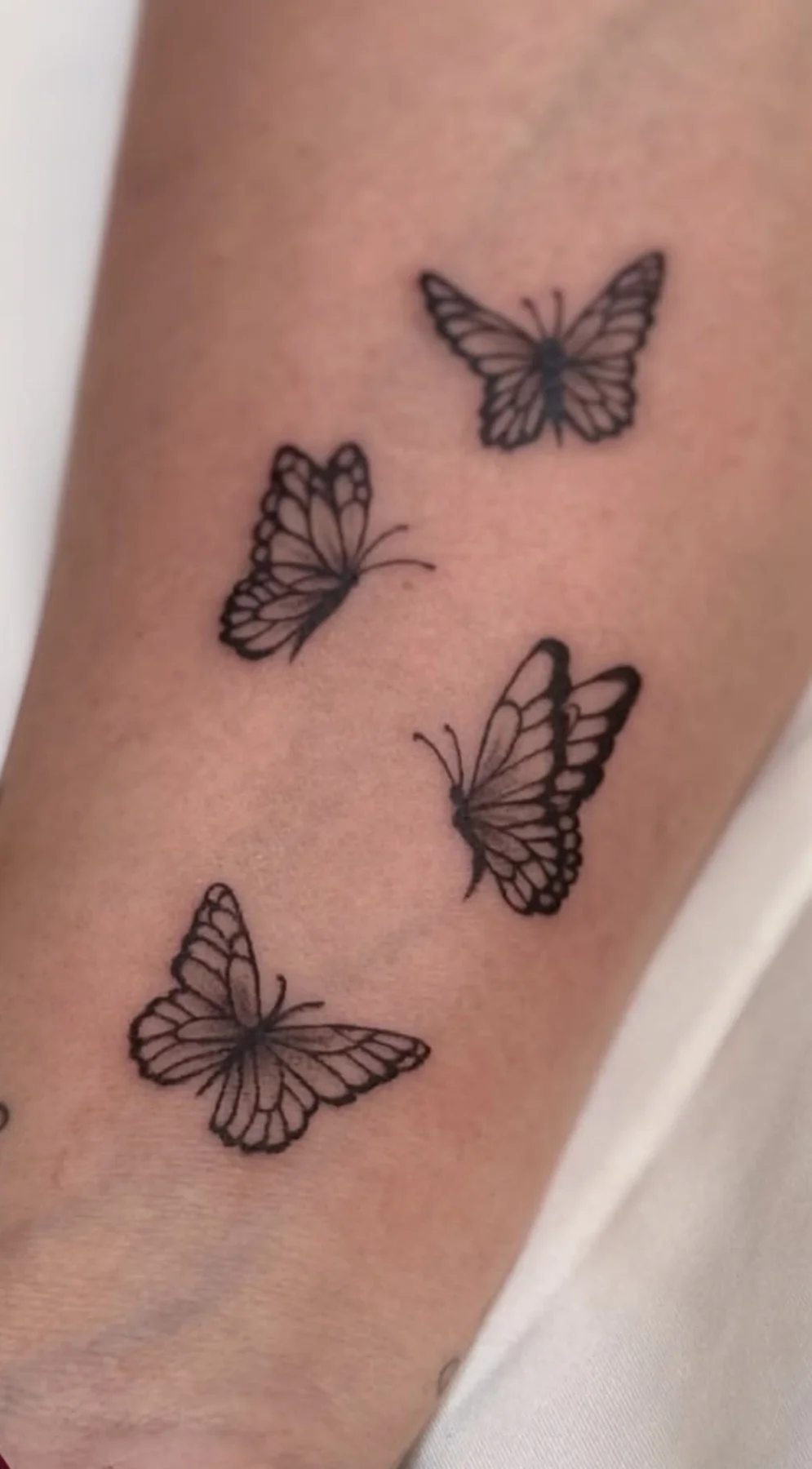 Fine-line butterfly tattoos by resident artist Valeriia S.
